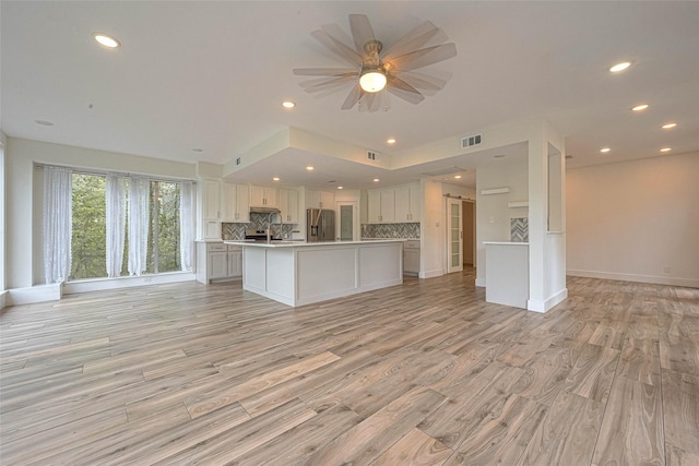 6628 Bayou Glen Rd Unit 6628, Houston, TX 77057 - kitchen featuring open floor plan, stainless steel fridge with ice dispenser, tasteful backsplash, light countertops, and recessed lighting