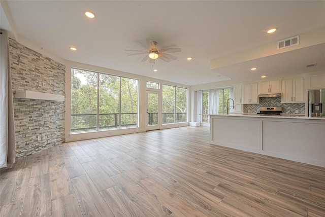 6628 Bayou Glen Rd Unit 6628, Houston, TX 77057 - unfurnished living room featuring a ceiling fan, recessed lighting, and light wood-style floors