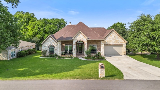 13336 Lake Breeze Ln, Willis, TX 77318 - french country home featuring stone siding, an attached garage, concrete driveway, a front yard, and a chimney