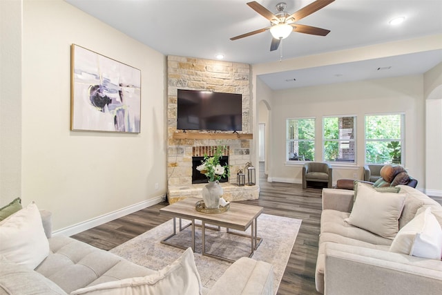 13336 Lake Breeze Ln, Willis, TX 77318 - living room featuring a ceiling fan, wood finished floors, a fireplace, arched walkways, and recessed lighting