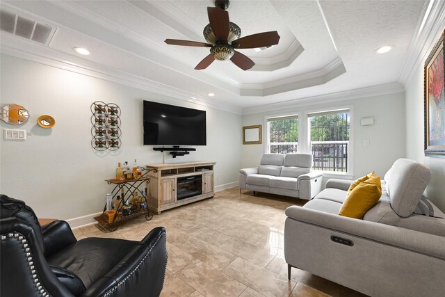 5227 Falvey St, Houston, TX 77017 - living room featuring crown molding, a ceiling fan, a tray ceiling, light tile patterned floors, and recessed lighting