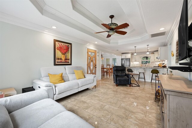 5227 Falvey St, Houston, TX 77017 - living area featuring crown molding, a raised ceiling, ceiling fan, and recessed lighting