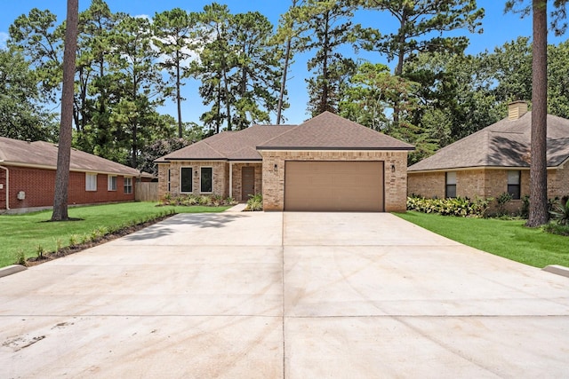 327 Paradise Ln, Montgomery, TX 77356 - view of front of home with brick siding, driveway, and a front yard