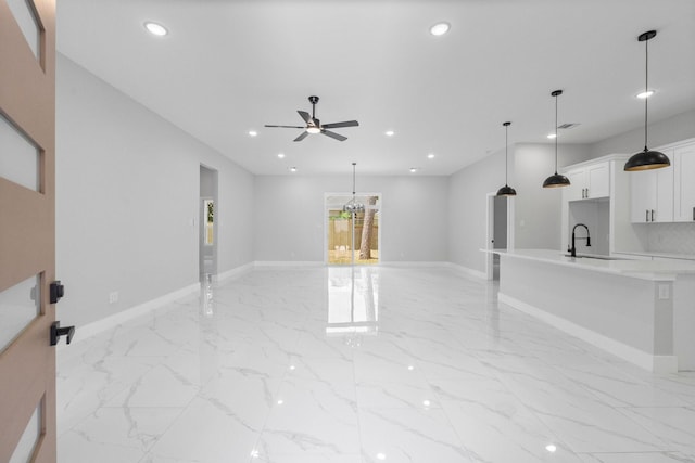 327 Paradise Ln, Montgomery, TX 77356 - unfurnished living room with a ceiling fan, light marble finish flooring, and recessed lighting
