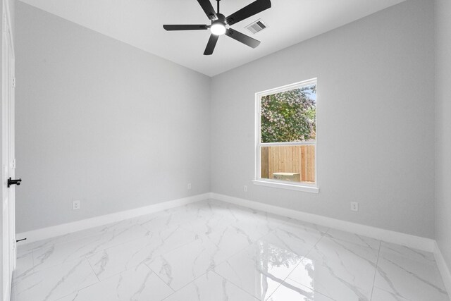 327 Paradise Ln, Montgomery, TX 77356 - unfurnished room featuring a ceiling fan and light marble finish floors