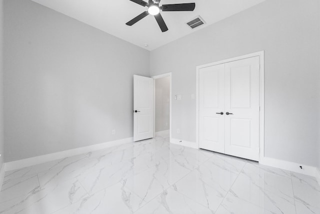 327 Paradise Ln, Montgomery, TX 77356 - unfurnished bedroom featuring light marble finish floors, ceiling fan, a towering ceiling, and a closet