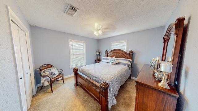 110 Four Master Rd, Freeport, TX 77541 - bedroom featuring light carpet, a textured ceiling, and a closet