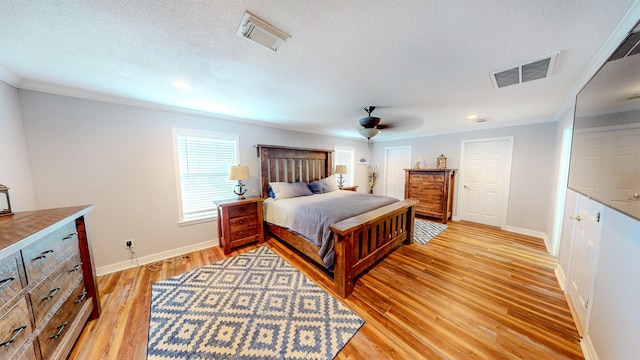 110 Four Master Rd, Freeport, TX 77541 - bedroom with crown molding, light wood-style flooring, recessed lighting, a ceiling fan, and a textured ceiling