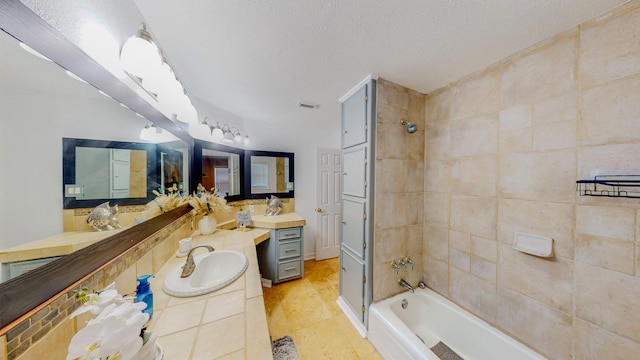 110 Four Master Rd, Freeport, TX 77541 - full bath featuring vanity, a textured ceiling, tile patterned flooring, and washtub / shower combination