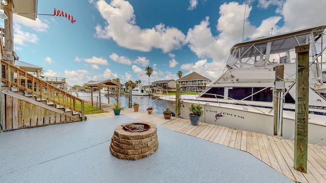110 Four Master Rd, Freeport, TX 77541 - view of patio featuring a fire pit, a water view, stairs, and a boat dock