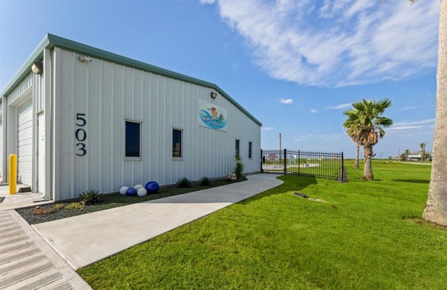 110 Four Master Rd, Freeport, TX 77541 - view of home's exterior with board and batten siding and an outbuilding