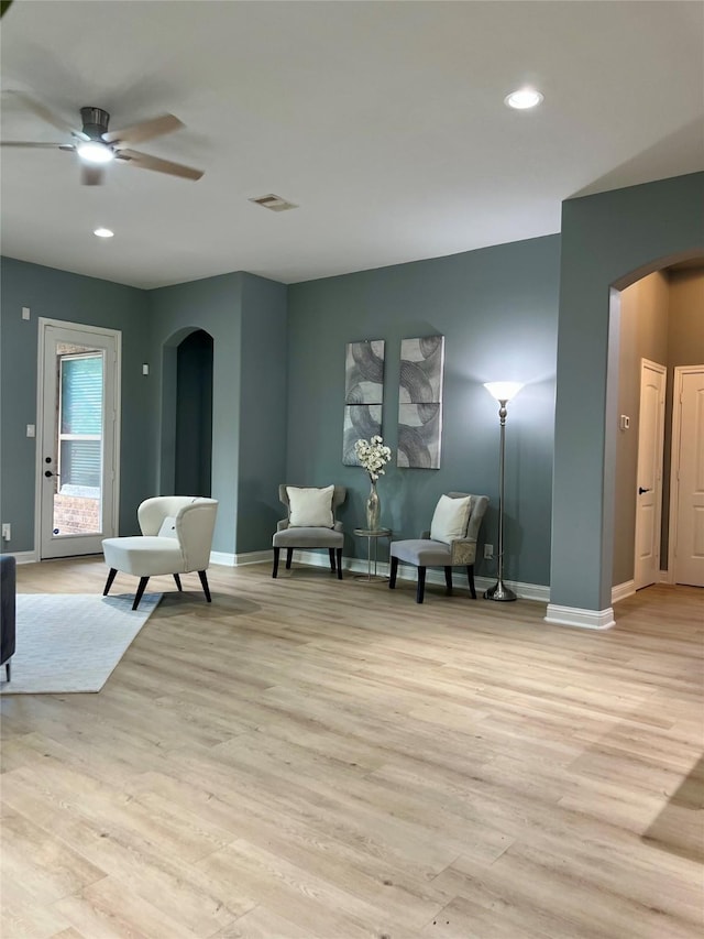 18718 Fairmont Springs Ct, Cypress, TX 77429 - living area with arched walkways, light wood-type flooring, ceiling fan, and recessed lighting