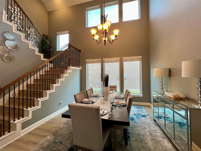 18718 Fairmont Springs Ct, Cypress, TX 77429 - dining space featuring stairway, a towering ceiling, a chandelier, and wood finished floors