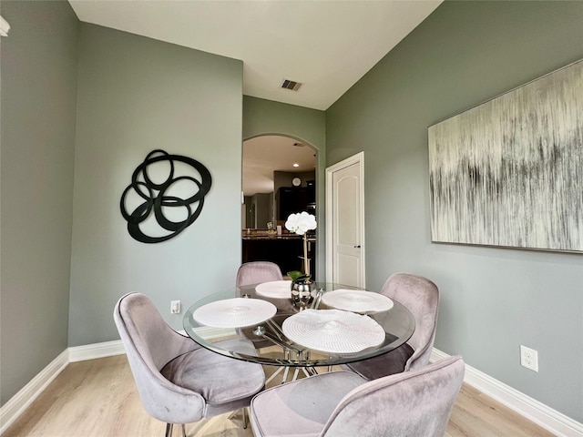 18718 Fairmont Springs Ct, Cypress, TX 77429 - dining room with arched walkways and light wood-type flooring