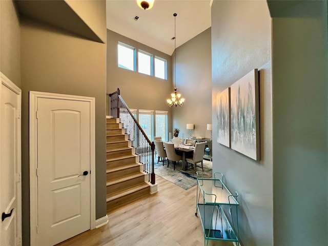 18718 Fairmont Springs Ct, Cypress, TX 77429 - entryway with a towering ceiling, a chandelier, plenty of natural light, light wood-style flooring, and stairs