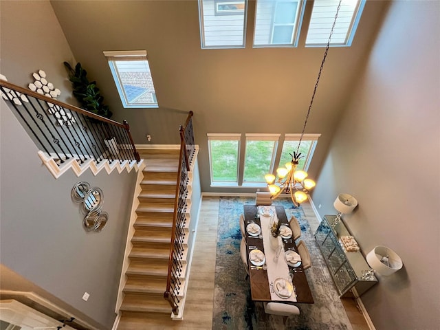 18718 Fairmont Springs Ct, Cypress, TX 77429 - stairs featuring wood finished floors, a chandelier, and a high ceiling
