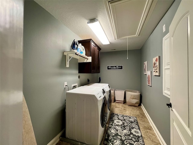 18718 Fairmont Springs Ct, Cypress, TX 77429 - laundry room featuring attic access, cabinet space, washing machine and dryer, and light stone finish floors