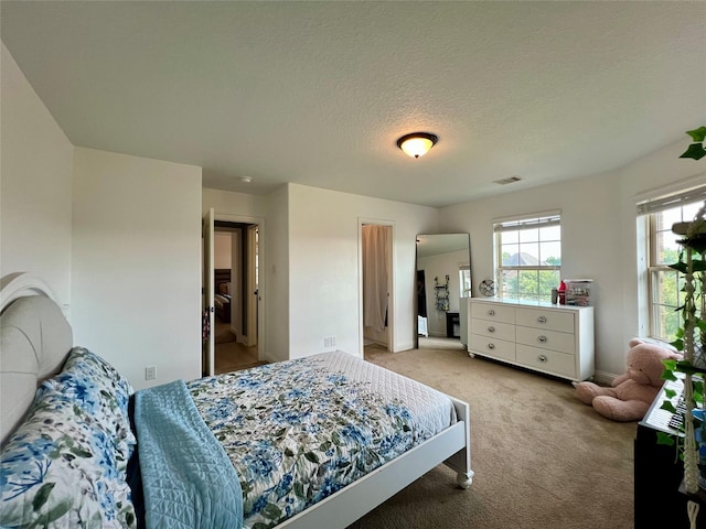 18718 Fairmont Springs Ct, Cypress, TX 77429 - bedroom featuring light carpet and a textured ceiling