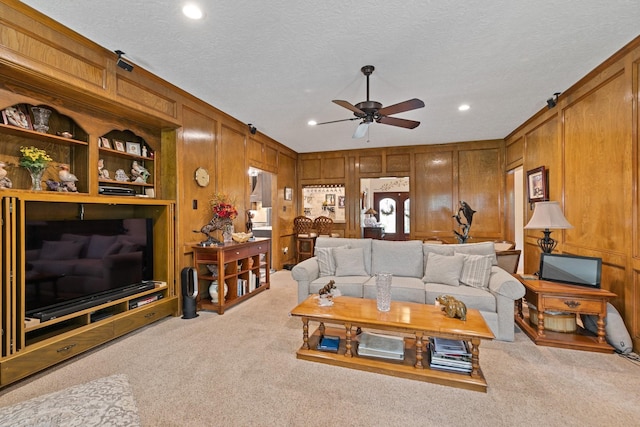 6430 Willow Pine Dr, Spring, TX 77379 - carpeted living area featuring a ceiling fan, recessed lighting, wooden walls, and a textured ceiling