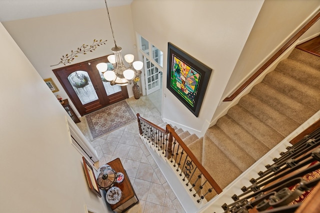 6430 Willow Pine Dr, Spring, TX 77379 - tiled entryway featuring high vaulted ceiling, stairway, french doors, and a chandelier
