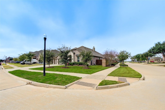 3502 Harper Ferry Pl, Katy, TX 77494 - view of front of property with concrete driveway, a front lawn, an attached garage, a residential view, and a chimney