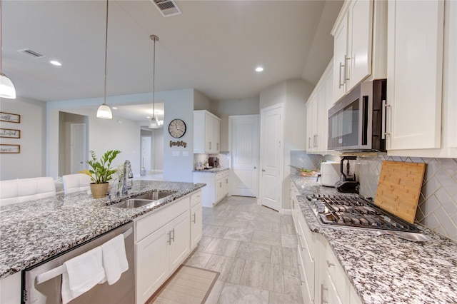 3502 Harper Ferry Pl, Katy, TX 77494 - kitchen featuring stainless steel appliances, decorative backsplash, recessed lighting, light stone counters, and white cabinetry