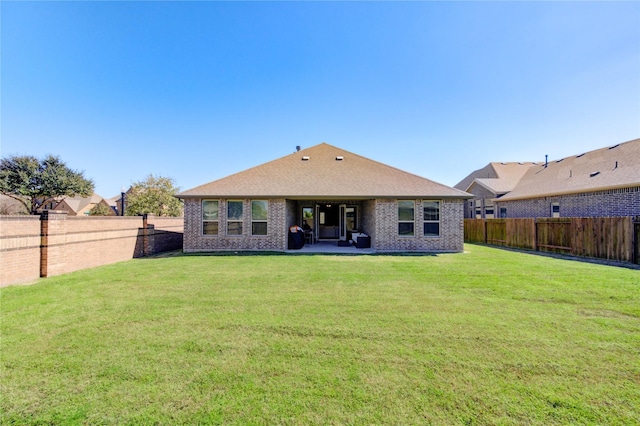 3502 Harper Ferry Pl, Katy, TX 77494 - back of property featuring a fenced backyard, brick siding, roof with shingles, and a patio