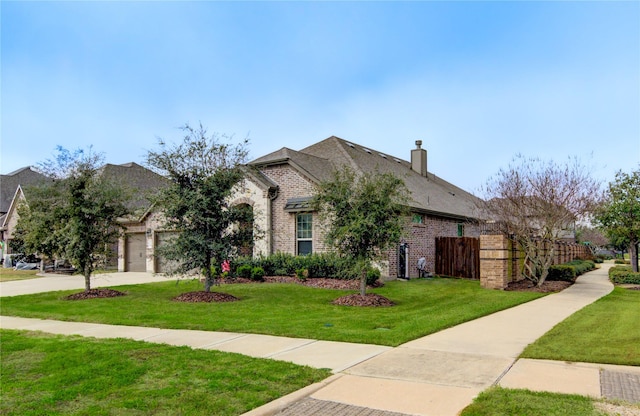 3502 Harper Ferry Pl, Katy, TX 77494 - view of front facade with brick siding, an attached garage, a chimney, and concrete driveway