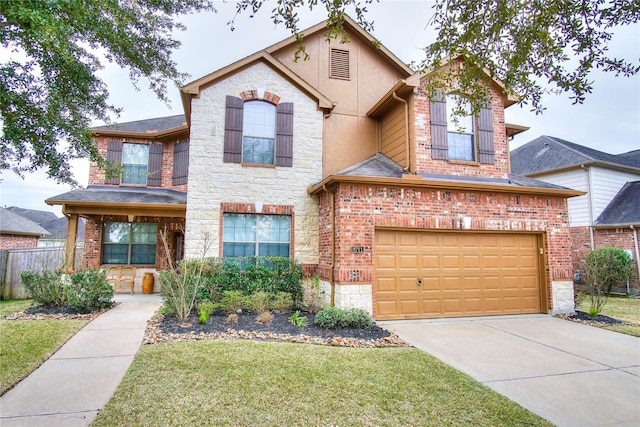 8711 Chamomile Meadow Trl, Katy, TX 77494 - view of front facade featuring an attached garage, stone siding, concrete driveway, and brick siding