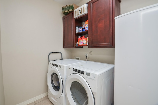 8711 Chamomile Meadow Trl, Katy, TX 77494 - washroom featuring cabinet space, washer and dryer, and light tile patterned flooring