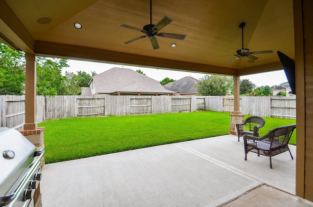 8711 Chamomile Meadow Trl, Katy, TX 77494 - fenced backyard with ceiling fan, a patio area, and area for grilling