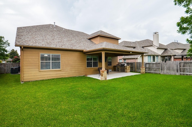 8711 Chamomile Meadow Trl, Katy, TX 77494 - back of house with a fenced backyard, a patio, and exterior kitchen