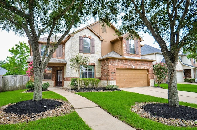 8711 Chamomile Meadow Trl, Katy, TX 77494 - view of front of property with a garage, stone siding, concrete driveway, and brick siding