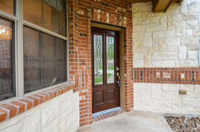 8711 Chamomile Meadow Trl, Katy, TX 77494 - entrance to property featuring brick siding, stone siding, and covered porch