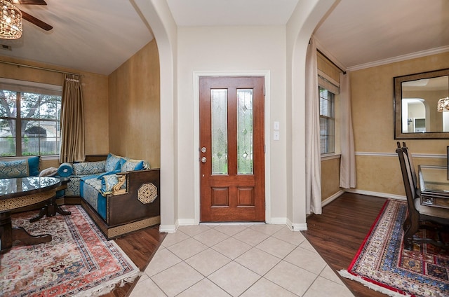 8711 Chamomile Meadow Trl, Katy, TX 77494 - foyer entrance with arched walkways, a ceiling fan, and wood finished floors
