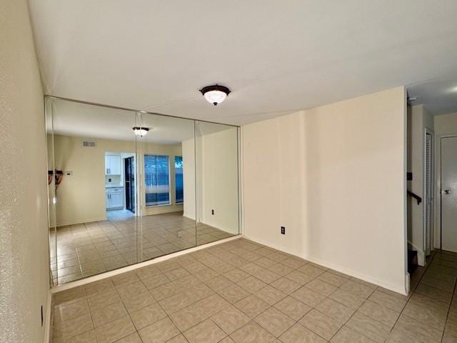 9001 Imogene St Unit A, Houston, TX 77036 - empty room with light tile patterned flooring and baseboards