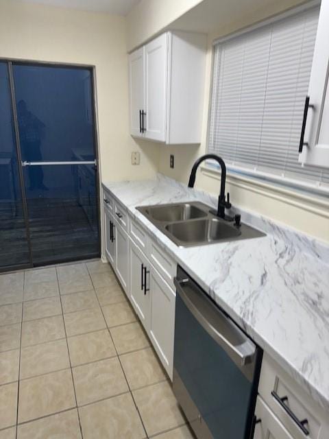 9001 Imogene St Unit A, Houston, TX 77036 - kitchen featuring dishwashing machine, white cabinets, light tile patterned floors, and light stone countertops