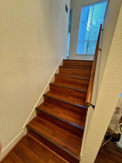 9001 Imogene St Unit A, Houston, TX 77036 - staircase featuring wood finished floors and baseboards