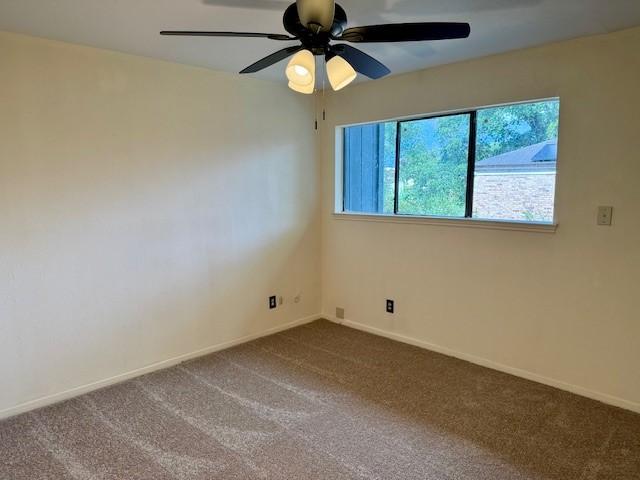 9001 Imogene St Unit A, Houston, TX 77036 - unfurnished room with dark colored carpet and ceiling fan
