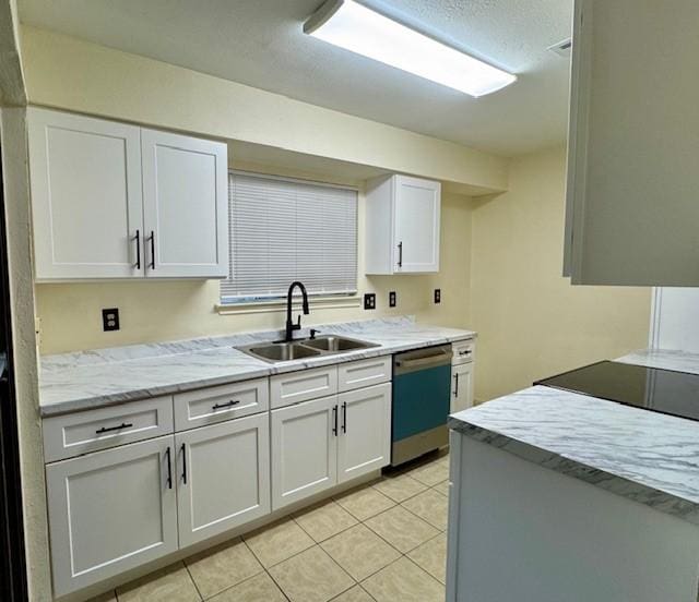 9001 Imogene St Unit A, Houston, TX 77036 - kitchen with dishwashing machine, white cabinets, light tile patterned floors, and range
