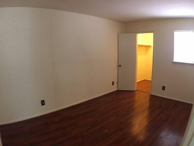 9001 Imogene St Unit A, Houston, TX 77036 - unfurnished room with dark wood-type flooring and baseboards