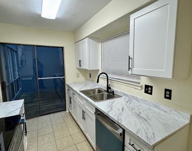 9001 Imogene St Unit A, Houston, TX 77036 - kitchen featuring appliances with stainless steel finishes, white cabinetry, light tile patterned flooring, light stone countertops, and a textured ceiling