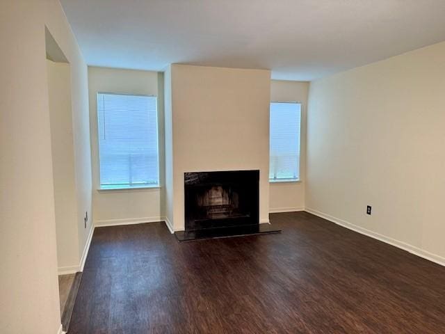 9001 Imogene St Unit A, Houston, TX 77036 - unfurnished living room with wood finished floors and a fireplace with raised hearth