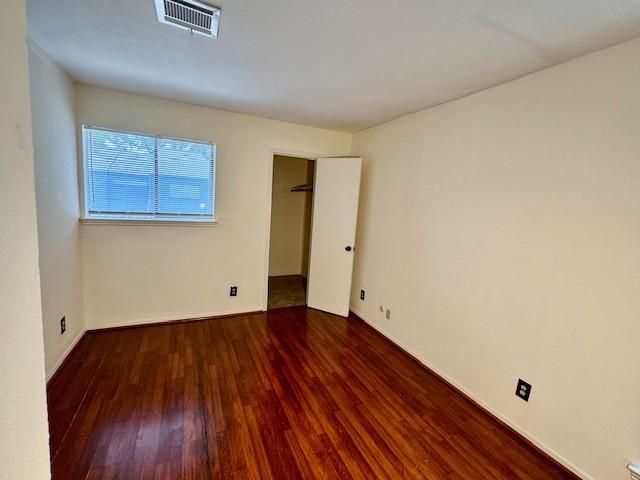 9001 Imogene St Unit A, Houston, TX 77036 - unfurnished bedroom featuring wood finished floors and baseboards