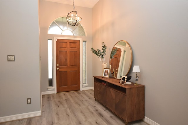 5113 Greenwater Dr, Willis, TX 77318 - foyer entrance featuring a chandelier, light wood finished floors, and a towering ceiling