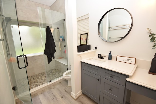 5113 Greenwater Dr, Willis, TX 77318 - full bathroom with vanity, wood finished floors, and a shower stall