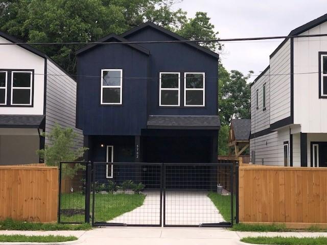 5702 Elysian St, Houston, TX 77009 - modern home featuring a fenced front yard, a gate, and covered porch