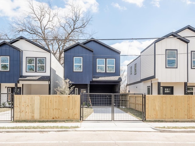 5702 Elysian St, Houston, TX 77009 - contemporary house featuring driveway, a fenced front yard, and a gate