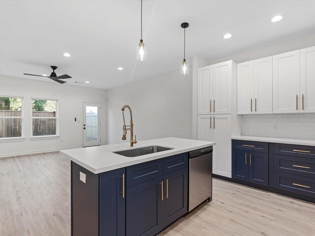 5702 Elysian St, Houston, TX 77009 - kitchen with stainless steel dishwasher, white cabinetry, light countertops, light wood-type flooring, and ceiling fan