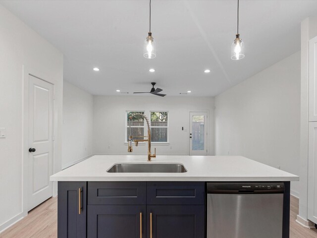 5702 Elysian St, Houston, TX 77009 - kitchen with stainless steel dishwasher, light wood-style floors, light countertops, recessed lighting, and decorative light fixtures